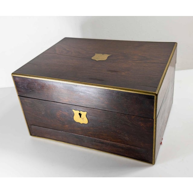 We are selling this nice English Rosewood veneered Vanity Case. This box has nice form with brass corners and a hidden...