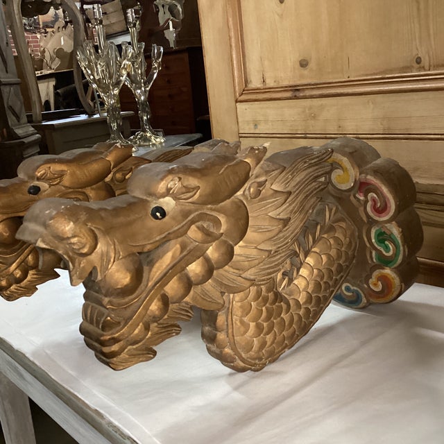 A pair of gloriously carved dragon wall sculptures from the mid 20th century. This vintage pair of hand-carved wood...