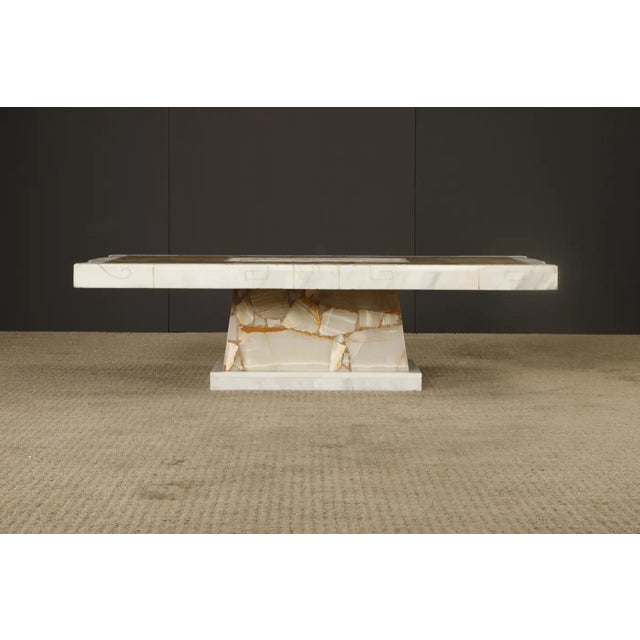 A striking vintage Italian tessellated stone coffee table, crafted from richly patterned onyx and alabaster. The...