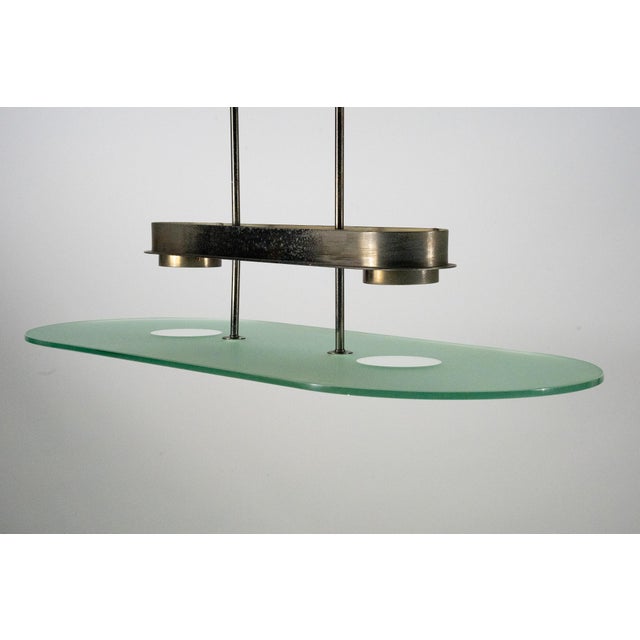 Elegant Mid-Century chandelier by Lumi Milano, crafted in Italy during the 1970s. This sophisticated piece features a...