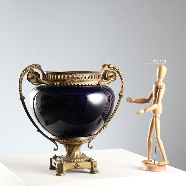 Cobalt blue porcelain and gilt bronze centerpiece. Square base with studs and garland, handles decorated with leafy...
