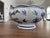 Chinese-style blue and white porcelain bowl featuring a crackle glaze finish, ruffled edge, and a floral and butterfly...