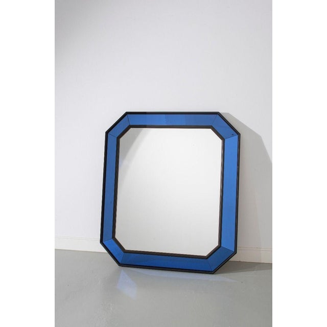 An impressively scaled mid-century Italian cushion mirror with a blue glass and ebonised wooden frame. In perfect...