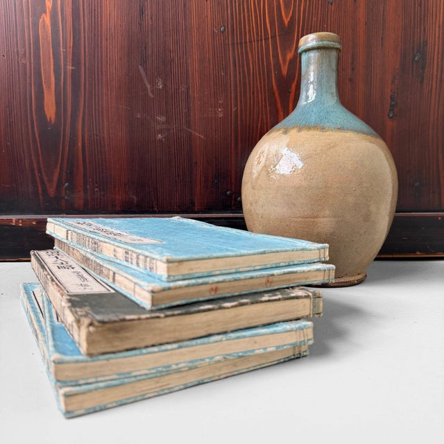 A characterful, handcrafted japanese sake bottle from the 1950s–60s, with a beautifully rounded form and distinctive...
