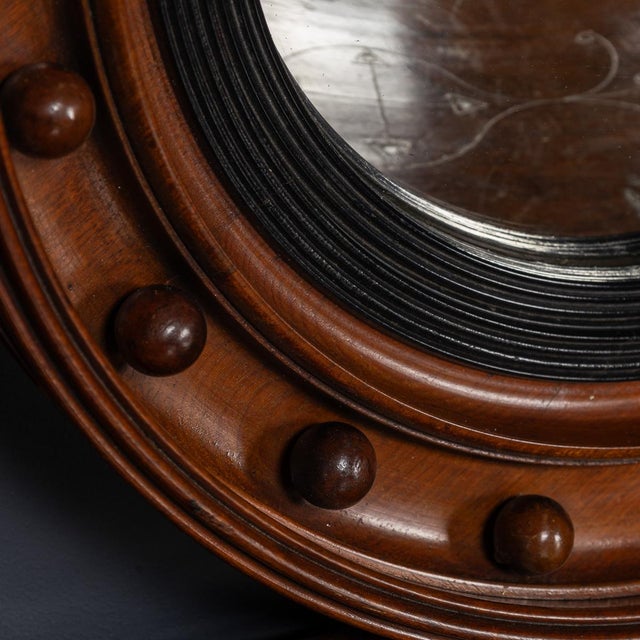 Antique 19th Century Regency mahogany & ebony framed convex mirror. On the surrounding frame, eighteen wooden spheres...