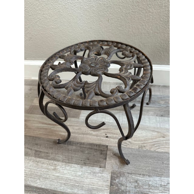 It is a very charming plant stand very likely from the 1940’s. It is charming small cast iron plant stand featuring an...