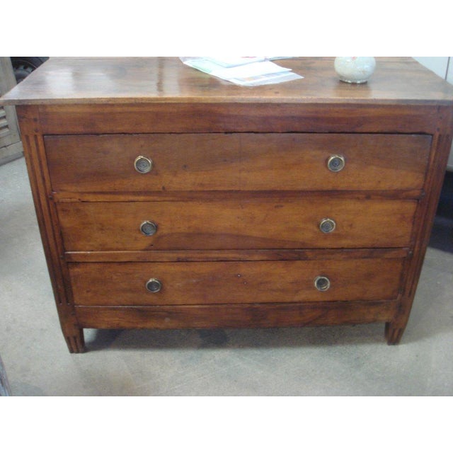Louis XVI Directoire commode from the late 18th Century. Walnut with three drawers with bronze circular hardware.