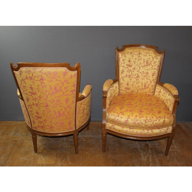 Pair of Louis XVI style walnut bergère armchairs, seat height 48 cm, carved and molded walnut, late 18th century, set in...