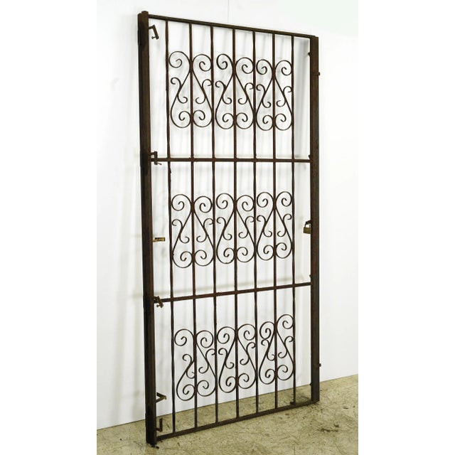 Reclaimed Victorian wrought iron outdoor gate with curled details. Good condition with surface wear from prior use with...