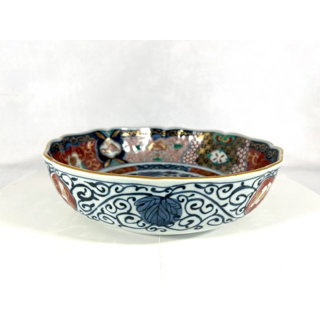 Lovely tones of blue, red, gold and green decorate this hand painted white porcelain Imari Japanese bowl. Highlighted with...