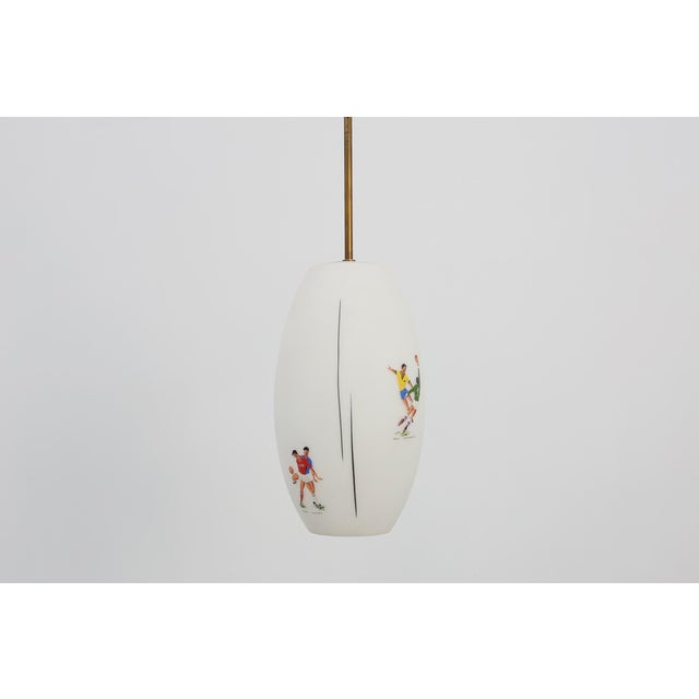 A rare and highly collectible pendant lamp celebrating the 1962 fifa world cup in chile, this 1960s british piece brings...