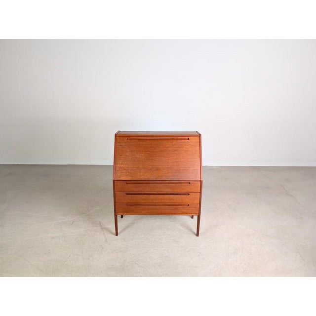 Beautiful teak secretary desk by HJN Mobler for sale. Designed by Nils Jonsson, it remains a design classic due to its...