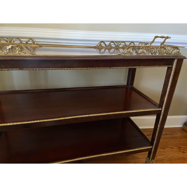 Inlay pattern gallery with intricate brass tooling accent. All shelves are completely surrounding with us brass, the legs...
