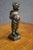 Charming early 20th-century bronze figure of a young boy dressed in a traditional Alpine or European country costume,...