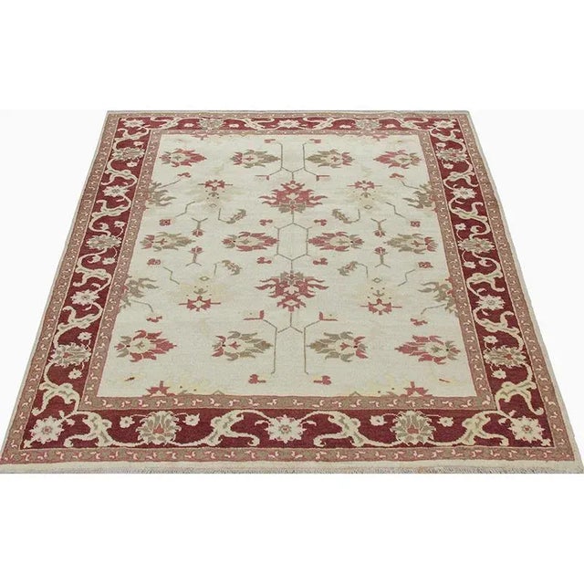 Traditional Handwoven Persian Heriz Area Rug featuring an allover design in a light cream-colored field enclosed in a...
