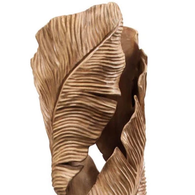 This striking mahogany sculpture showcases an organic, twisting form of layered leaves, beautifully carved with intricate...