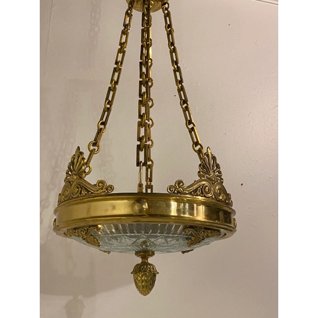 A circa 1900's French Empire gilt bronze chandelier with cut glass Inset