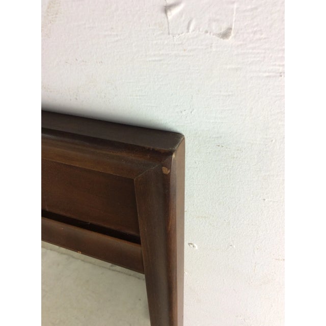 This mid century modern mirror features hardwood frame, original finish, beveled edge and unique walnut inlay at the top....