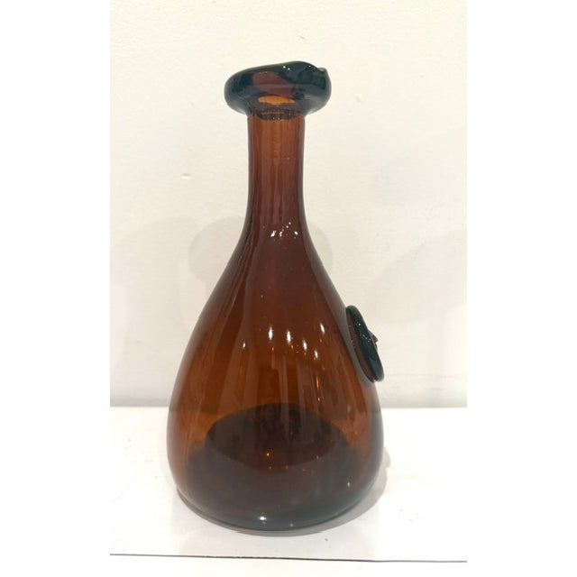 An iconic piece of Danish Holmegaard Glass in the form a large amber glass Viking Carafe. Designed by Ole Withers in the...