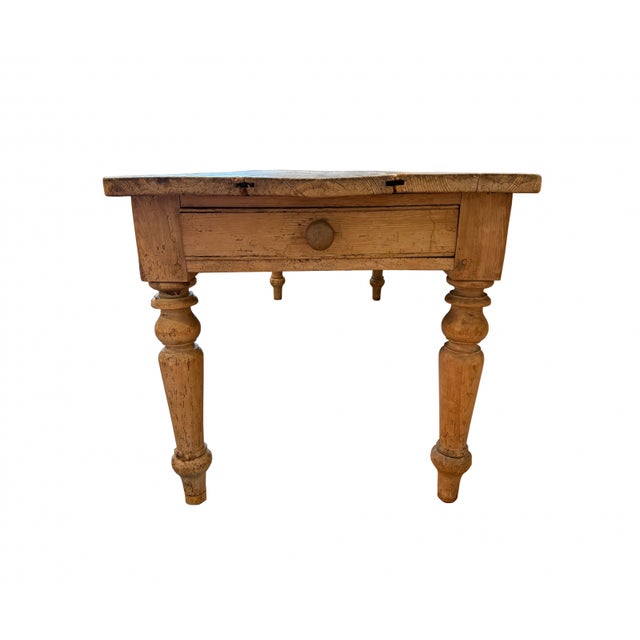 This rustic 19th century French Louis Philippe farm work table is crafted from oak with peg joinery. The plank top...