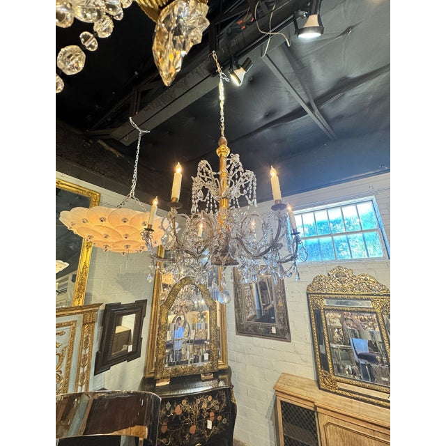 The product is a 19th century Italian giltwood and crystal chandelier, adding a touch of elegance and sophistication to...