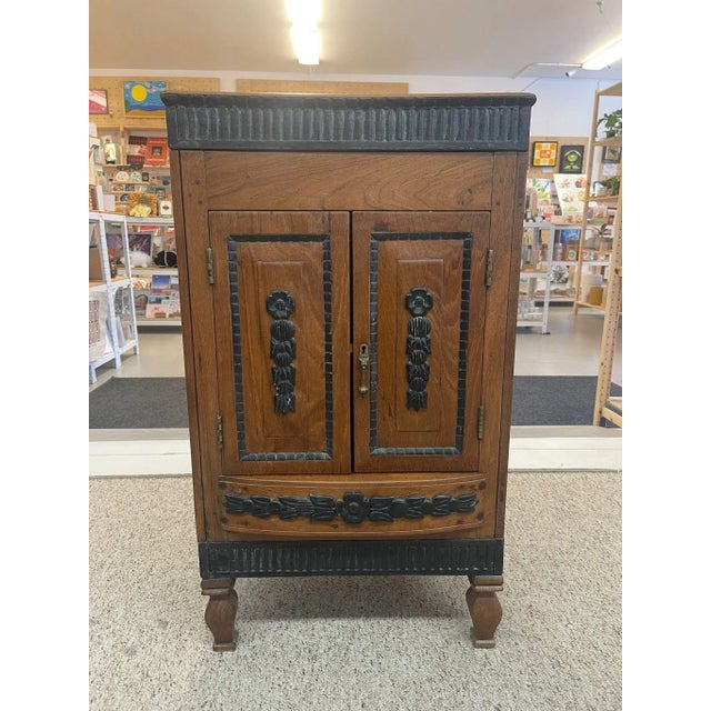 This Dutch colonial cabinet opens from the top, front and back as shown. Every side is enhanced with Carved wood Floral...