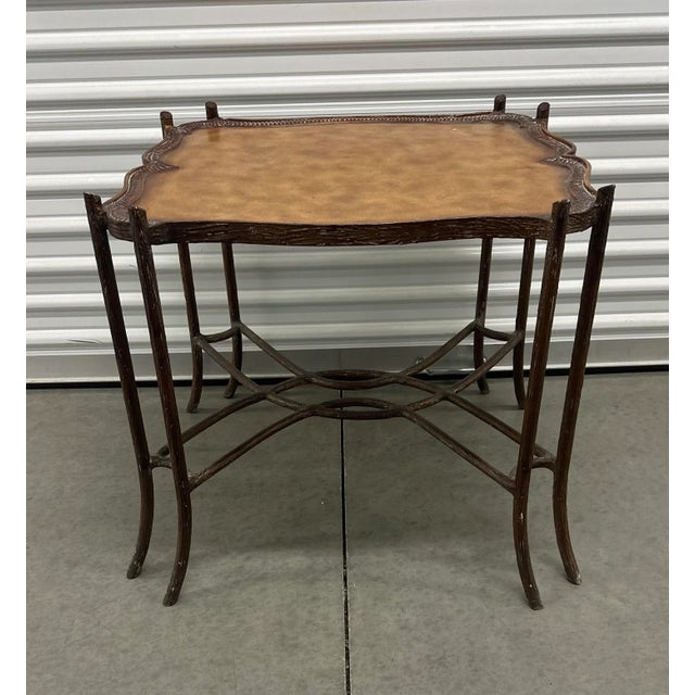 Stunning iron faux bois table features a double curved x-base, double corner faux bois legs, and a beautiful leather...
