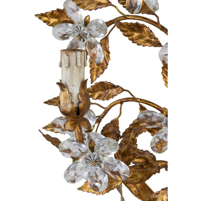 Gilded Brass Applique in the style of Hans Kogl, late 20th Century. 2 lights, with cristal drops in the shape of flowers....