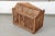 An antique wooden rectangular birdcage constructed of thinly hand carved wooden slats with a peaked A-framed roof, corner...
