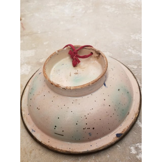 Colorful antique ceramic bowl from the middle east..possibly Turkey. This has a metal rim mounted on it and a hole for...