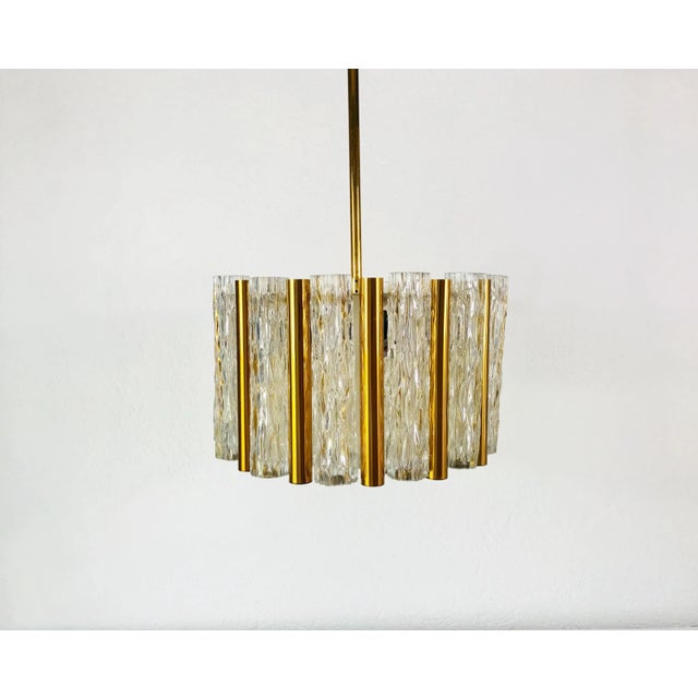 A Kaiser Leuchten ice glass chandelier made in Germany in the 1960s. It is fascinating with its rare tube glass shapes. A...