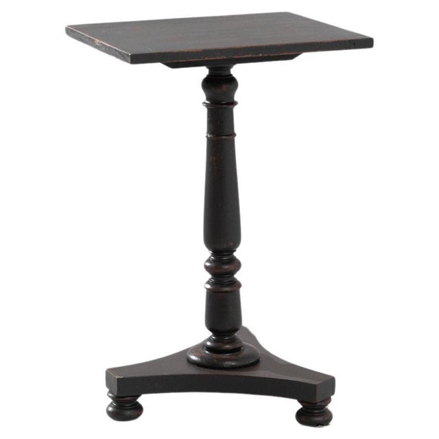 This 1900s British wood patinated side table is a charming relic from the past, bringing with it a warmth of history and...