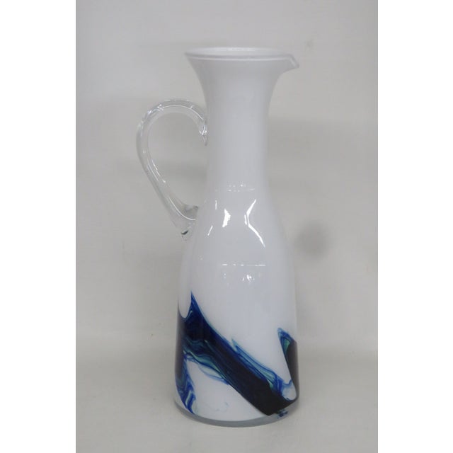 This brilliant Pitcher is made of glass. This impressive art glass pitcher / jug/vase is made in the wonderful style of...