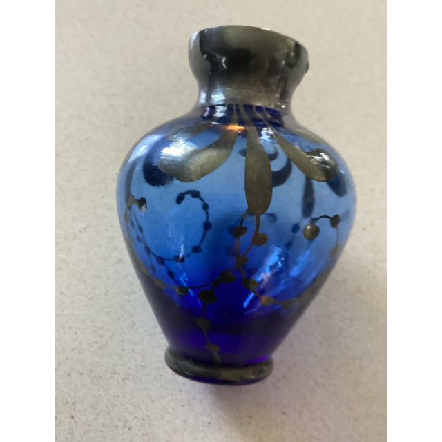 Vintage Murano hand blown mini bud vase in Cobalt Blue with an overlay of silver rim. Features a swirl design. Measures 3”...