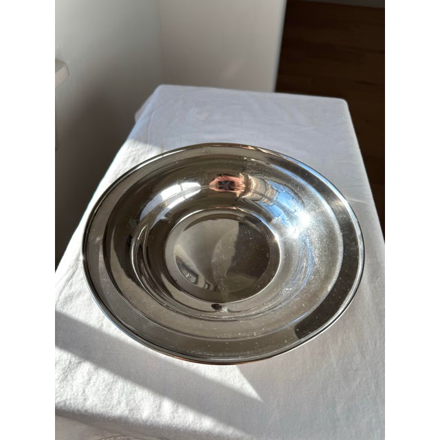 Vintage sterling silver bowl featuring a smooth, unadorned rim and a clean, minimalist silhouette that emphasizes form and...