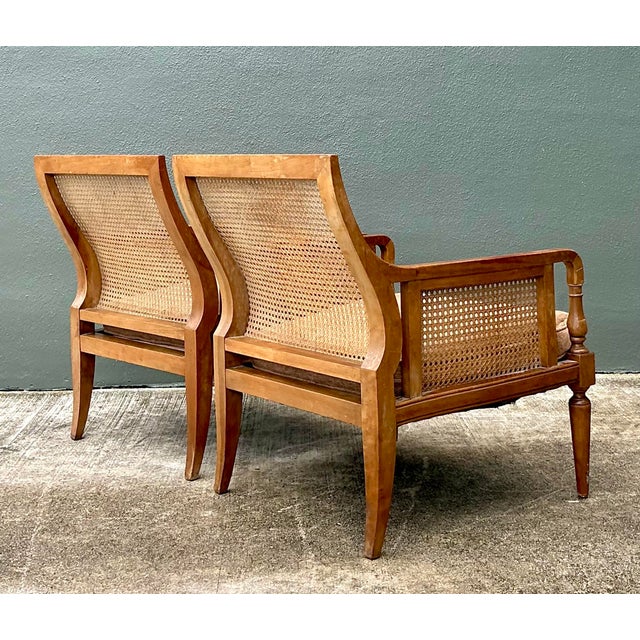 Exude timeless sophistication with this exceptional pair of lounge chairs by the esteemed Baker Furniture company. A...