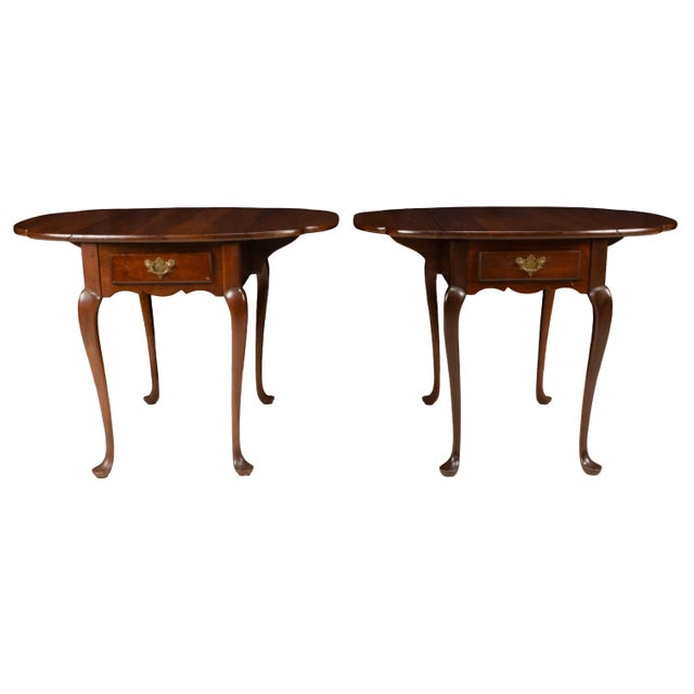 Matching pair of Hitchcock drop leaf side tables crafted in solid cherry with a warm traditional finish. Each table...
