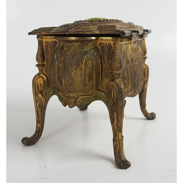 Antique late 19th century gilt brass regency era style jewelry box. Highly decoratated in relief, puffy green velvet...