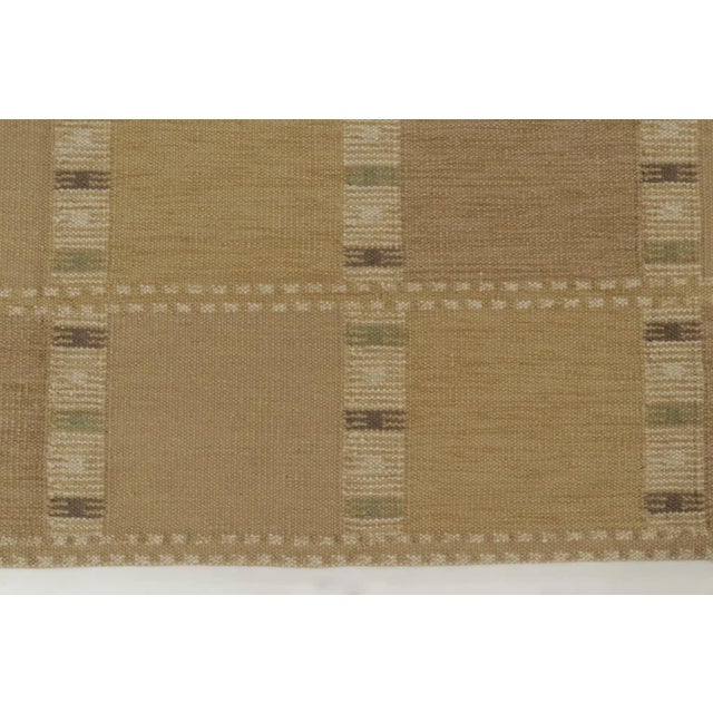 Handwoven in wool, this oversized 10x14 Scandinavian flatweave rug presents a refined geometric design in layered beige,...