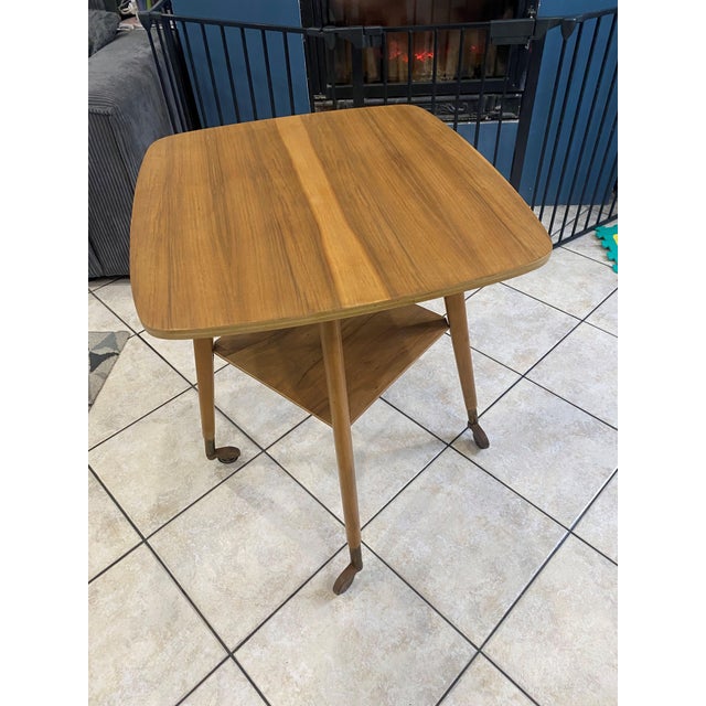 Very rare and original rotating table in excellent condition. Compass-style legs with casters. Length 63cm Width 57cm...