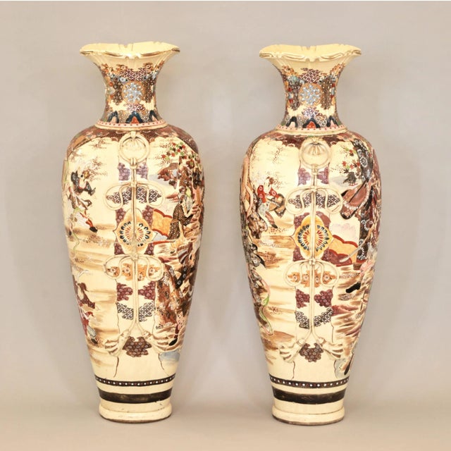 A pair of large outdoor Japanese Satsuma vases. End of the 19th century. Signatures on bases. Decorated with scenes of a...
