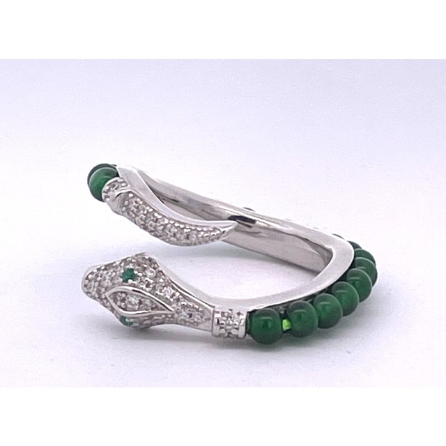 This stunning wrap-style cocktail ring features an open bypass design set in polished silver. The band is elegantly lined...