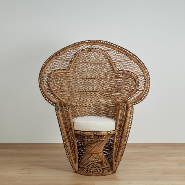 Exotic vintage Anglo Indian peacock chair with an unusual chair within a chair form, handcrafted in wicker and reed with...