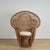Exotic vintage Anglo Indian peacock chair with an unusual chair within a chair form, handcrafted in wicker and reed with...