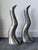 Crafted from solid cast aluminum, these candlesticks captivate with their fluid, organic lines, evoking two silhouettes or...