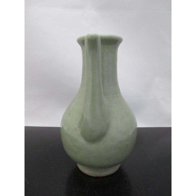 Chinese Longquan Celadon ewer. Jade green glazed pottery vessel with long handle and spout. Originated in the Longquan...