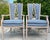 Elegant pair of vintage French Provincial style armchairs featuring tall shaped backs with intricate open foliate...