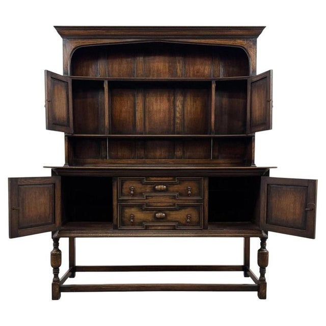 An impressive early 20th-century English dresser in the Jacobean Revival style, finely crafted from oak and distinguished...