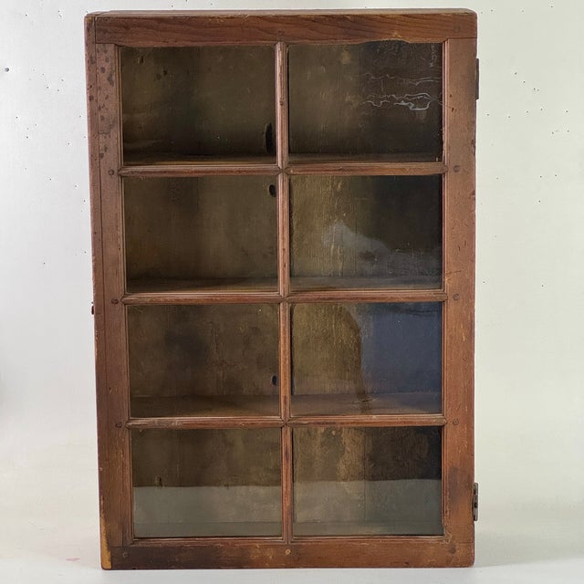 A gorgeous Late 19th - Early 20th Century hand crafted large wooden antique cabinet/cupboard. Its straightforward...