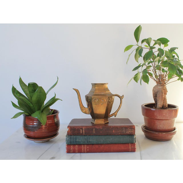 Vintage petite brass teapot. Made in Taiwan. No lid. One very small hole near the bottom of the handle. Makers mark on the...